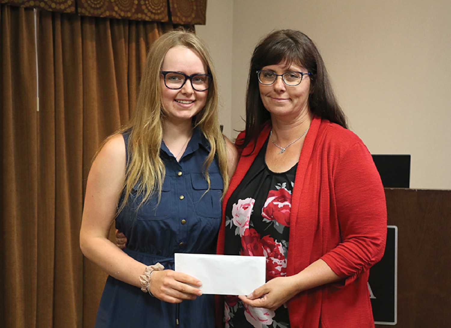 Ricayla Gawryluk of Whitewood presented her donation of $3,384 for the Moosomin Airport Expansion Project to RM of Moosomin CAO Kendra Lawrence, at Tuesday’s Moosomin Chamber of Commerce meeting.